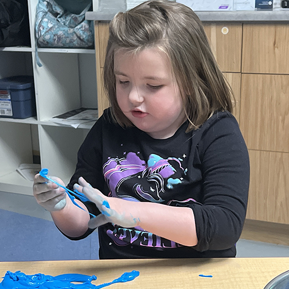 Girl with slime sensory play